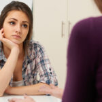 Teenage Girl Suffering From Depression Visiting Counsellor