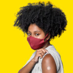 black teenager wearing protective mask against covid-19
